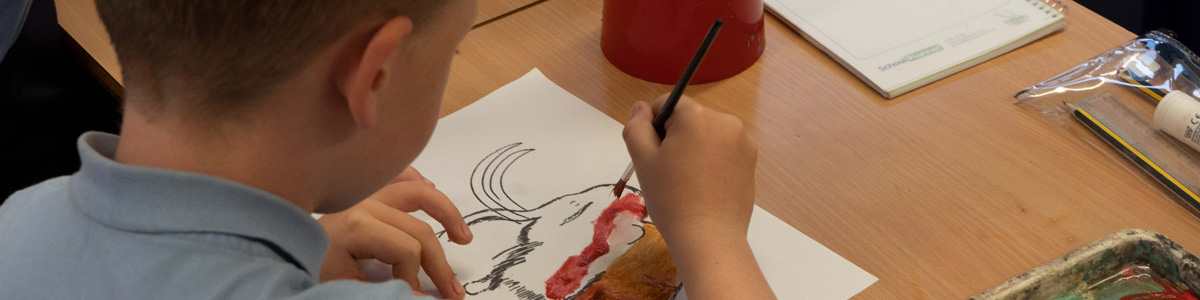 A child Painting a mammoth picture in a cave painting activity during a Marvellous History prehistoric workshop