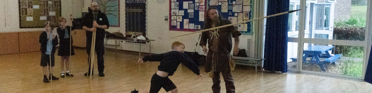 A child throwing a spear during a mammoth hunting game at a Marvellous History prehistoric visit
