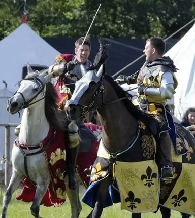 A picture of medieval jousters on horseback