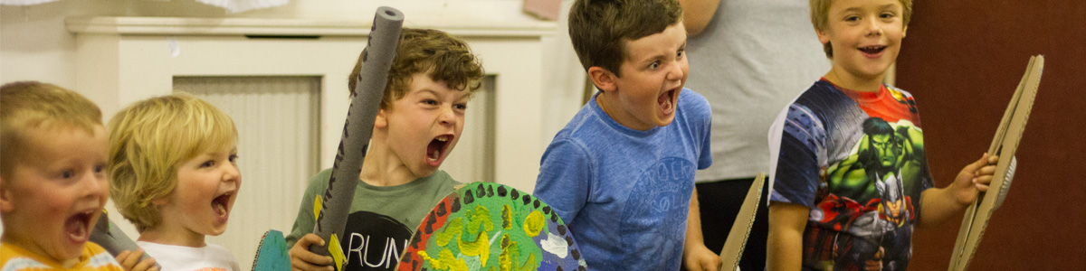 Primary school children shouting in a shield wall very eagerly 